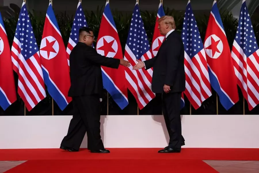 U.S. President Donald Trump shakes hands with North Korean leader Kim Jong Un at the Capella Hotel on Sentosa island in Singapore June 12, 2018.