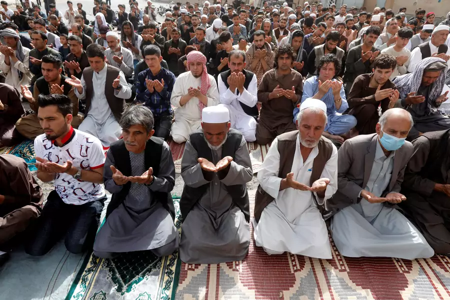 People take part in morning prayers to celebrate the first day of the Muslim holiday of Eid al-Fitr, marking the end of the holy month of Ramadan, in Kabul, Afghanistan, on June 15, 2018.
