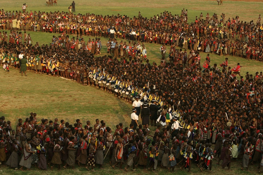 Bare-breasted virgins competing for King Mswati III's eye take part in a traditional reed dance at Ludzidzini, Swaziland August 31, 2008. The reed dance in South Africa was just a dance performance, unlike the one pictured in Swaziland.