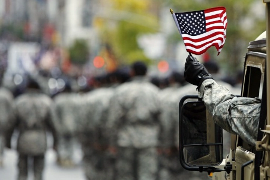 U.S. Army serviceman waves an American flag during a Veterans Day parade in New York. 