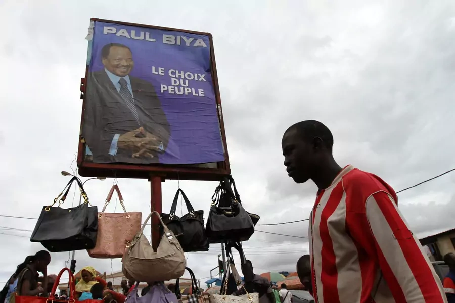 A campaign billboard featuring Cameroon's President Paul Biya is seen in the Makolo market a day before the country's presidential election in Yaounde October 8, 2011.