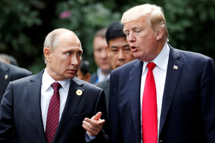 FILE PHOTO: U.S. President Donald Trump and Russia's President Vladimir Putin talk during the family photo session at the APEC Summit in Danang, Vietnam November 11, 2017.