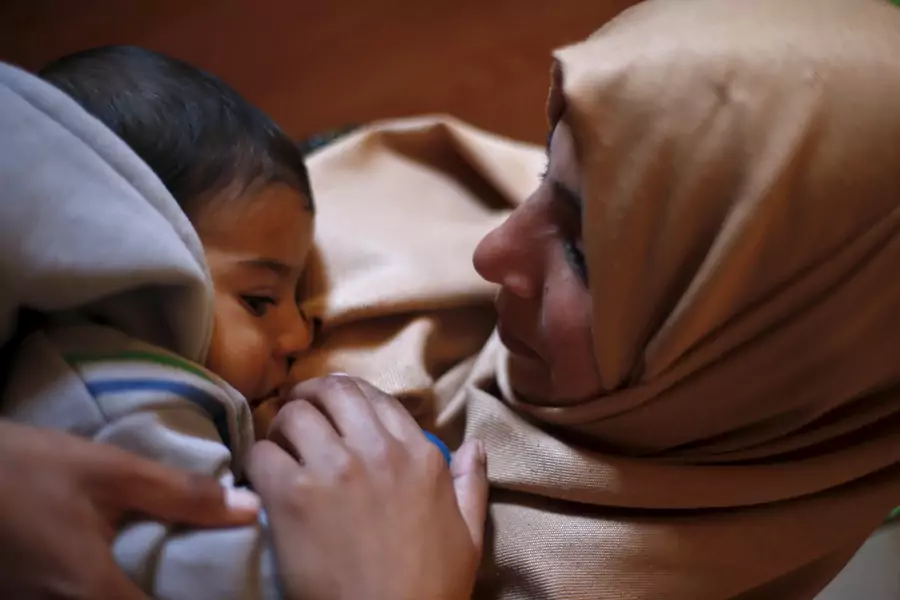 Syrian refugee Burooq Al Zubi, 21, breastfeeds her nine-month-old son Fares at Al Zaatari refugee camp in the Jordanian city of Mafraq.