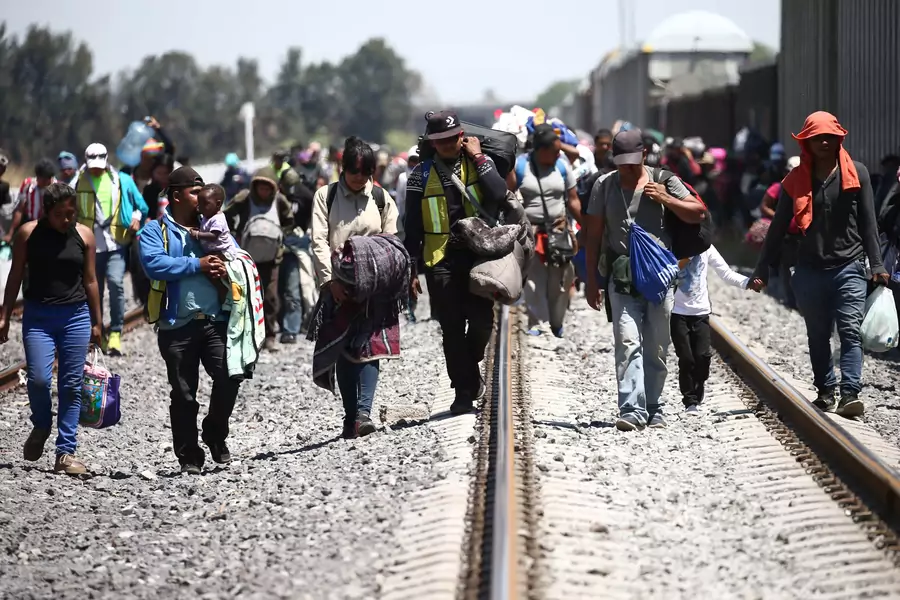 Central American migrants disembark from a freight train as they walk on a railway track after stopping the train on a rail line, in Irapuato, Guanajuato state, Mexico April 15, 2018. 