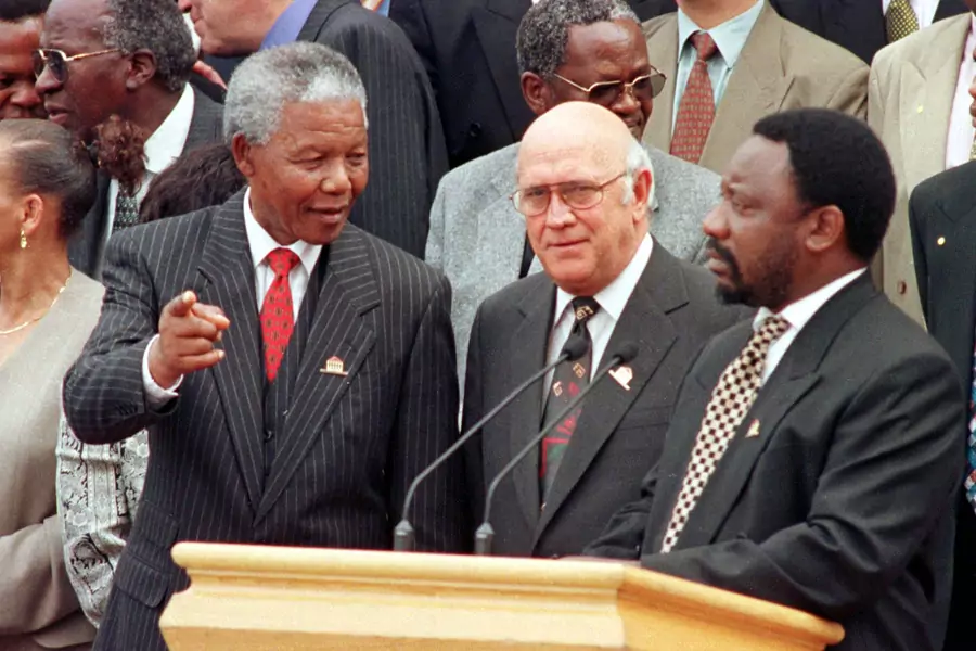President Nelson Mandela chats with Deputy President F.W. de Klerk and Constitutional Assembly chair Cyril Ramaphosa outside Parliament after the approval of South Africa's new constitution, May 8, 1996.