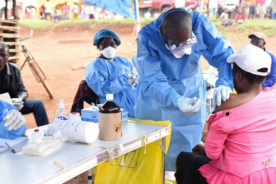 A Congolese health worker administers Ebola vaccine to a woman who had contact with an Ebola sufferer in the village of Mangina in North Kivu province of the Democratic Republic of Congo, August 18, 2018. 