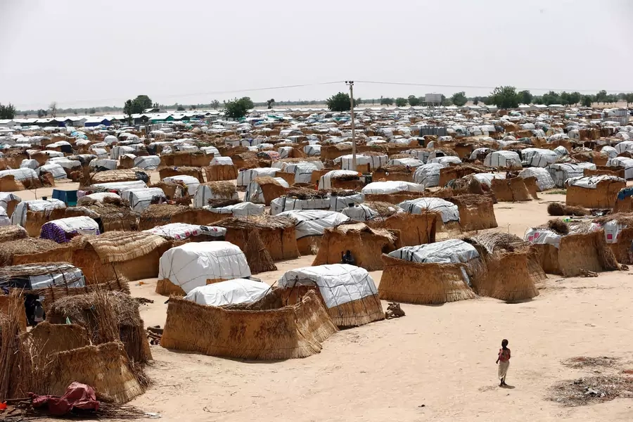A girl walks through makeshift sheds at an internally displaced persons (IDP) camp on the outskirts of Maiduguri, northeast Nigeria June 6, 2017. 