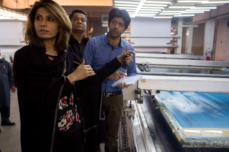 Erum Ahmed, chief executive officer (CEO) of the textile retail brand So Kamal, talks to workers as she visits a factory in Faisalabad.