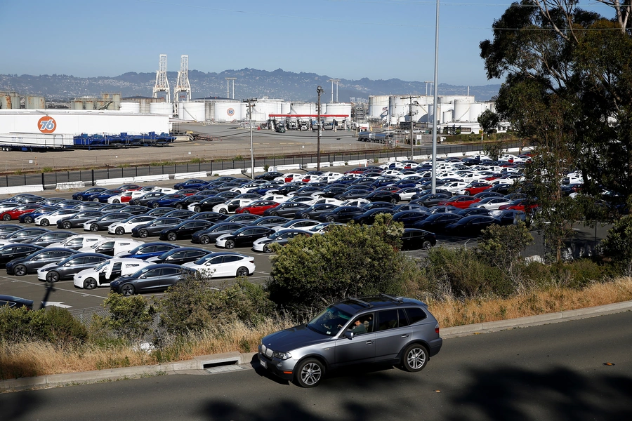 A motorist drives past a parking lot full of new Tesla electric vehicles in Richmond, California, U.S. June 22, 2018.