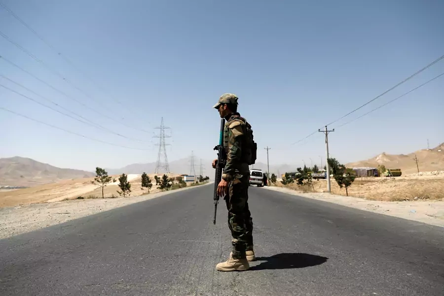 An Afghan National Army soldier keeps watch at a checkpoint on the Ghazni highway in Afghanistan on August 12, 2018.