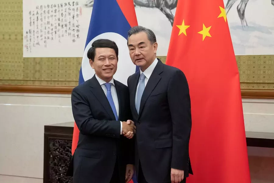Chinese Foreign Minister Wang Yi and his counterpart from Laos, Saleumxay Kommasith, shake hands at Diaoyutai State Guesthouse in Beijing, China on August 26, 2018.