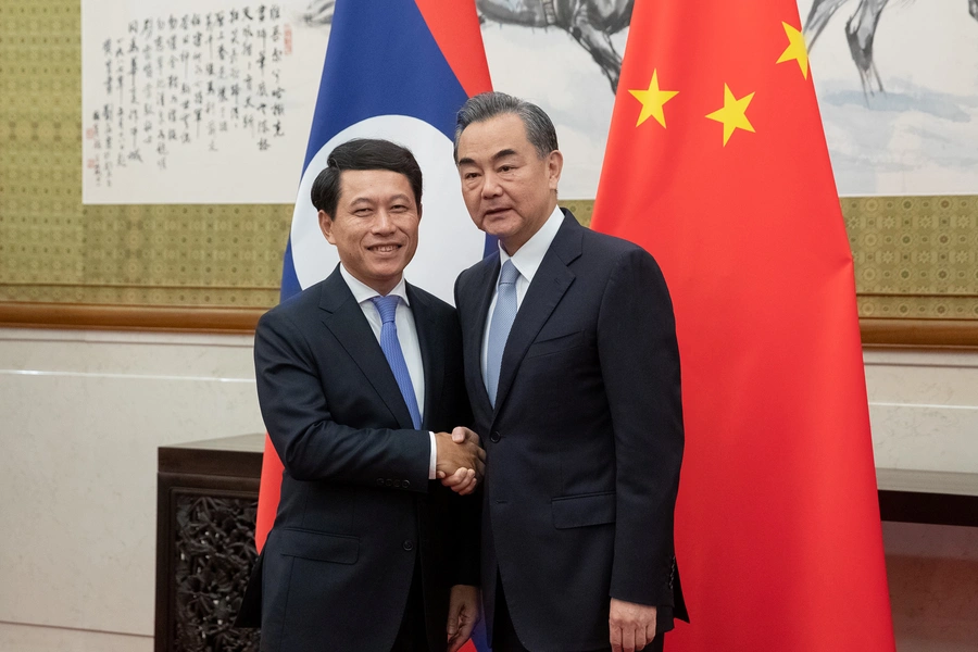 Chinese Foreign Minister Wang Yi and his counterpart from Laos, Saleumxay Kommasith, shake hands at Diaoyutai State Guesthouse in Beijing, China on August 26, 2018.