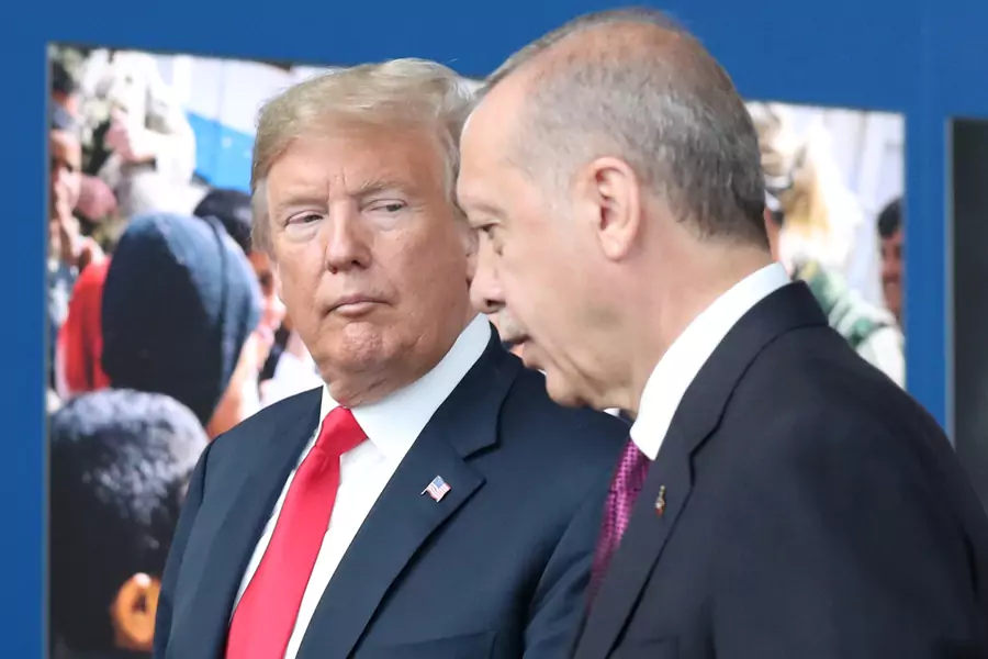 U.S. President Donald Trump talks to Turkey's President Recep Tayyip Erdogan at NATO headquarters in Brussels, Belgium July 11, 2018