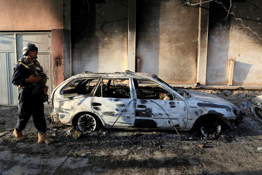 An Afghan policeman inspects the site of an attack in Jalalabad, Afghanistan, on July 31, 2018.