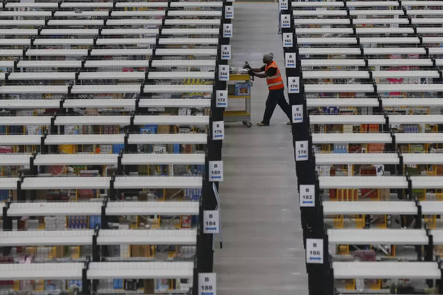 A worker collects orders at Amazon's fulfilment centre in Rugeley, central England December 11, 2012. 