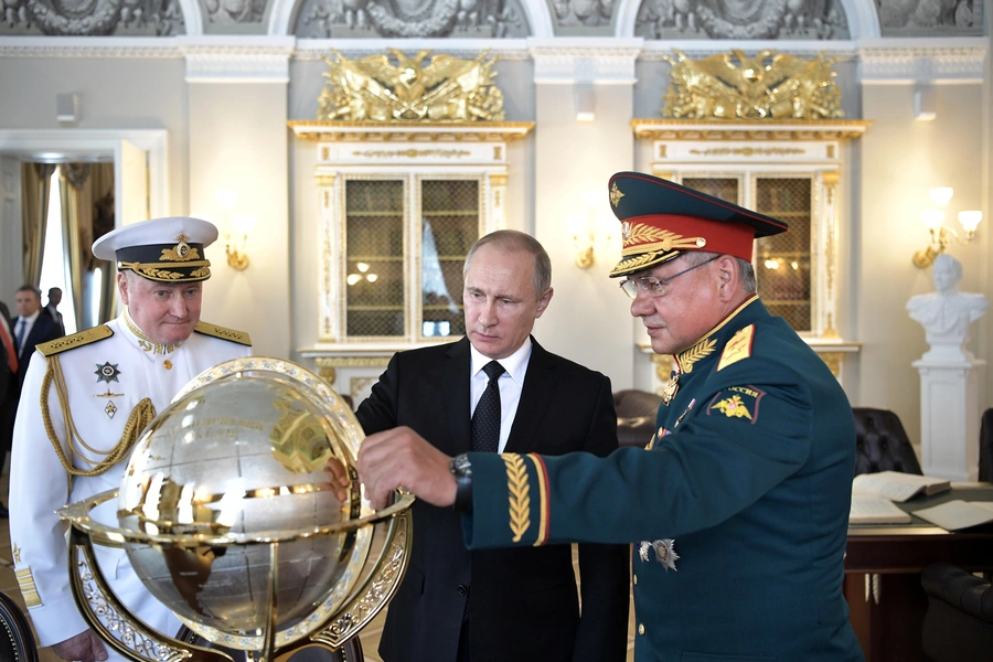 Russian President Vladimir Putin (C), Defence Minister Sergei Shoigu (R) and Commander-in-Chief of the Russian Navy Vladimir Korolev visit the Admiralty historical building on the Navy Day in St. Petersburg, Russia, July 30, 2017