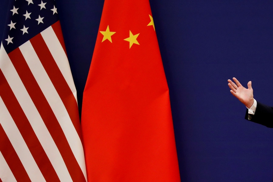 U.S. President Donald Trump delivers his speech next to U.S. and Chinese flags.