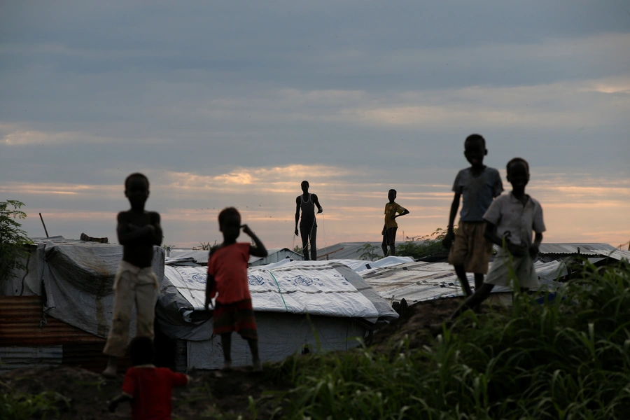 Internally displaced people stand on roofs in the Protection of Civilians Camp run by the UN Mission in South Sudan on September 8, 2018. 