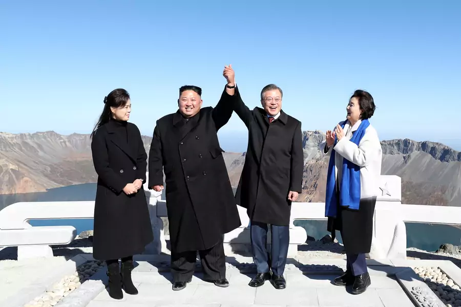 South Korean President Moon Jae-in and North Korean leader Kim Jong-un pose for photographs on the top of Mt. Paektu, North Korea.