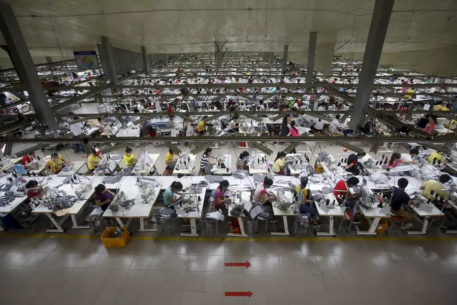 Laborers work at a garment factory in Bac Giang province, near Hanoi, Vietnam on October 21, 2015.