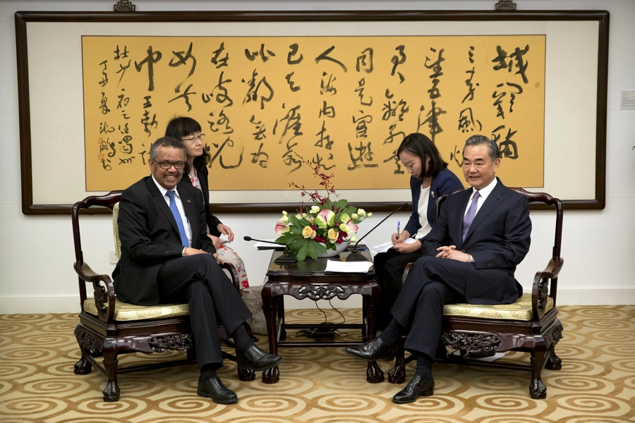 Tedros Adhanom Ghebreyesus, left, Director General of the World Health Organization, and Chinese Foreign Minister Wang Yi, right, before the start of a meeting at the Ministry of Foreign Affairs in Beijing on July 17, 2018. 