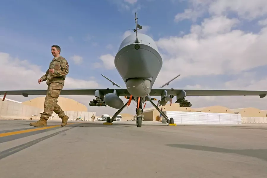A U.S. service member passes in front of a MQ-9 Reaper drone, one of a squadron that has arrived to step up the fight against the Taliban, at the Kandahar air base, Afghanistan January 23, 2018.