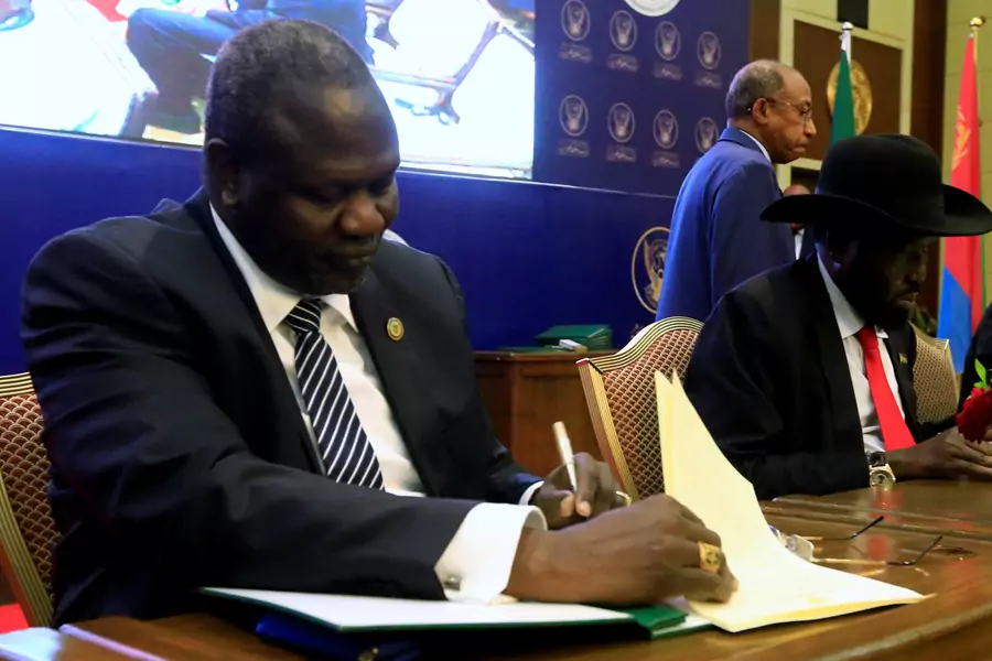 South Sudanese rebel leader Riek Machar (L) and South Sudan's President Salva Kiir sign a cease fire and power sharing agreement in Khartoum, Sudan August 5, 2018.