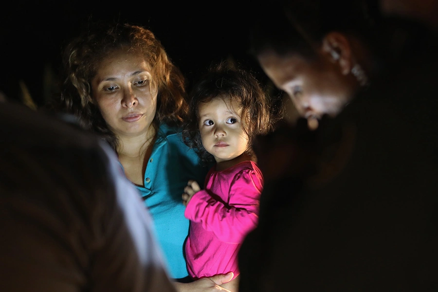 Central American asylum seekers, including a Honduran girl, 2, and her mother, are taken into custody near the U.S.-Mexico border on June 12, 2018 in McAllen, Texas.