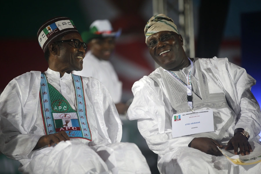 Current PDP presidential candidate Atiku Abubakar speaks with current President Muhammadu Buhari of the APC in Lagos on December 11, 2014, when both were contesting for the APC presidential nomination.