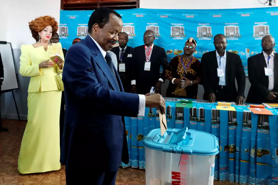 Cameroonian President Paul Biya casts his ballot while his wife Chantal watches during the presidential election in Yaounde, Cameroon October 7, 2018. 