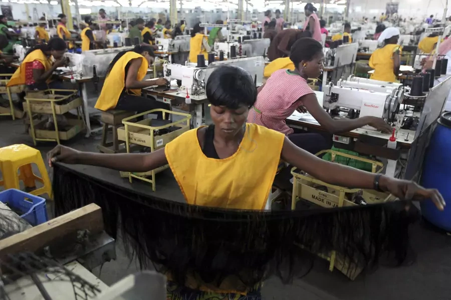 Women work in a fiber hair factory in Ikeja district in Lagos, Nigeria. December 1, 2011.