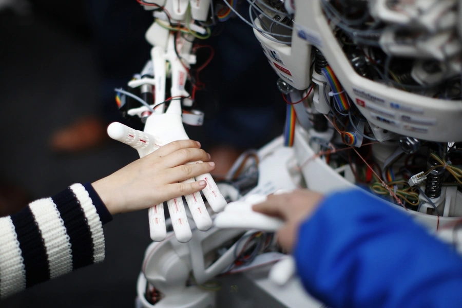Children touch the hands of the humanoid robot Roboy at the exhibition Robots on Tour in Zurich on March 9, 2013. 