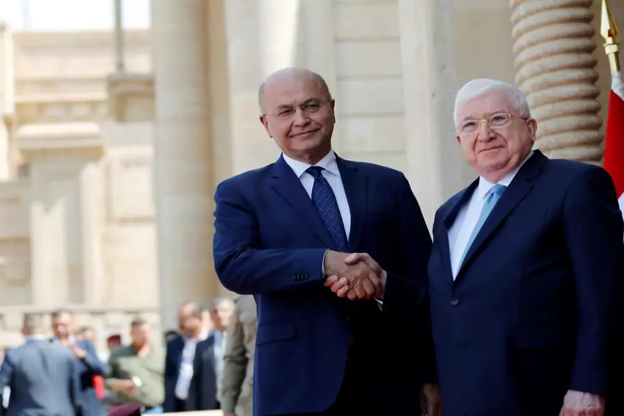 Iraq's outgoing President Fuad Masum and newly elected President Barham Salih shake hands at a ceremony held at Salam Palace in Baghdad, Iraq, on October 3, 2018. 