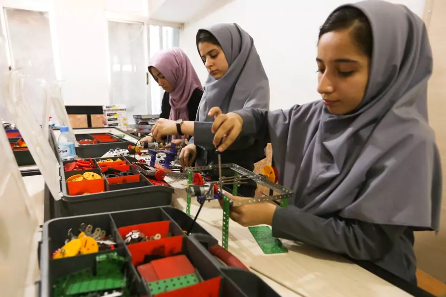 Members of Afghan robotics girls team work on their robots in Herat province.