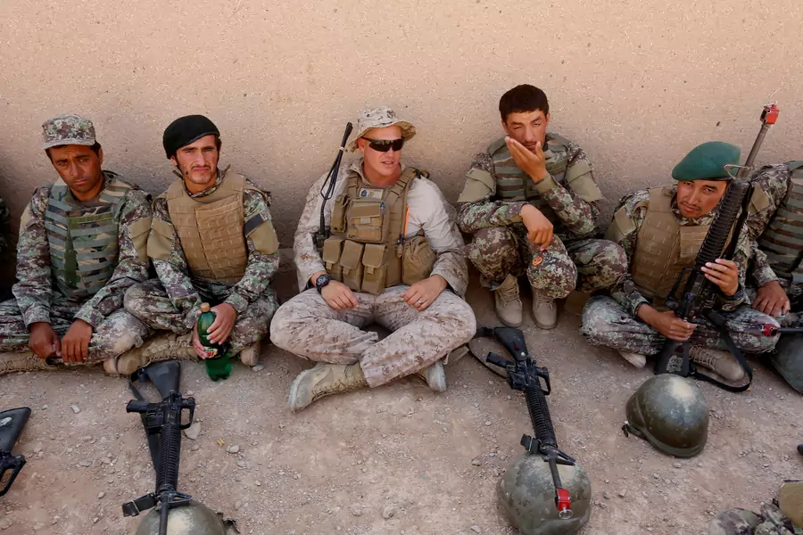 A U.S. Marine talks with Afghan National Army soldiers during a training in Helmand province, Afghanistan.