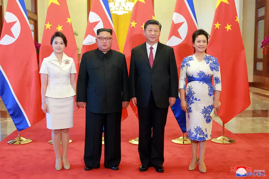 North Korean leader Kim Jong-un and his wife Ri Sol-ju pose beside Chinese President Xi Jinping and his wife Peng Liyuan in Beijing, China, in this undated photo released June 20, 2018 by North Korea's Korean Central News Agency.
