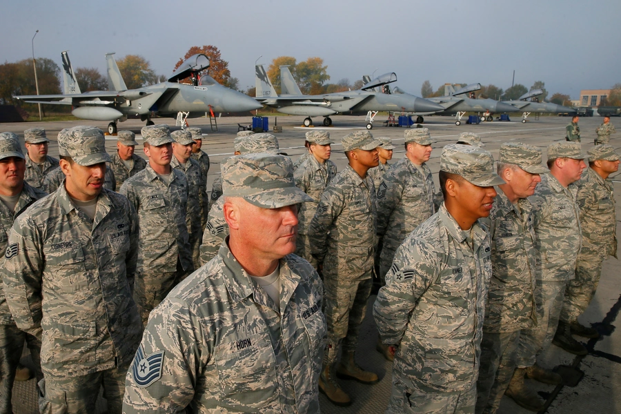 U.S. servicemen stand in line in front of F-15 fighter jets during the opening ceremony of the Clear Sky 2018 multinational military drills at Starokostiantyniv Air Base in Ukraine on October 12, 2018. 