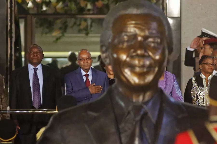 Jacob Zuma, president of South Africa at the time, stands with then-vice president and current President Cyril Ramaphosa behind a statue of former South African President Nelson Mandela outside Parliament in Cape Town on June 17, 2014.