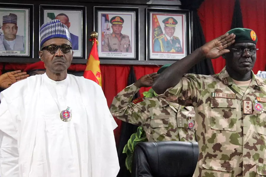 Nigerian President Muhammadu Buhari next to Nigeria Chief of Army Staff Tukur Buratai during the opening ceremony of the military staff annual conference, on November 28, 2018, as part of his trip to visit troops on front lines of the Boko Haram.