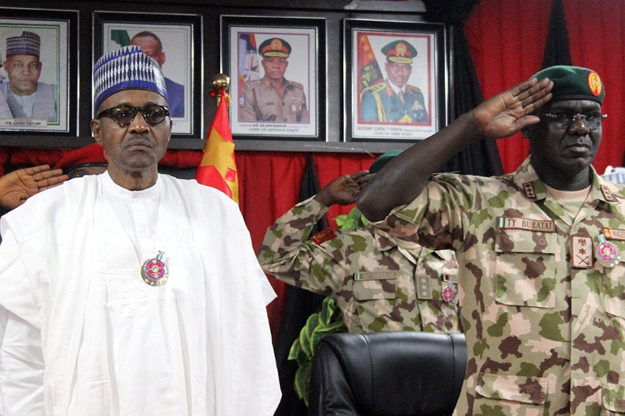 Nigerian President Muhammadu Buhari next to Nigeria Chief of Army Staff Tukur Buratai during the opening ceremony of the military staff annual conference, on November 28, 2018, as part of his trip to visit troops on front lines of the Boko Haram.