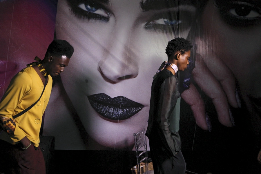 Models wearing clothes designed by Orange Culture leave the backstage at Lagos Fashion and Design Week in Lagos, Nigeria, on October 29, 2015.