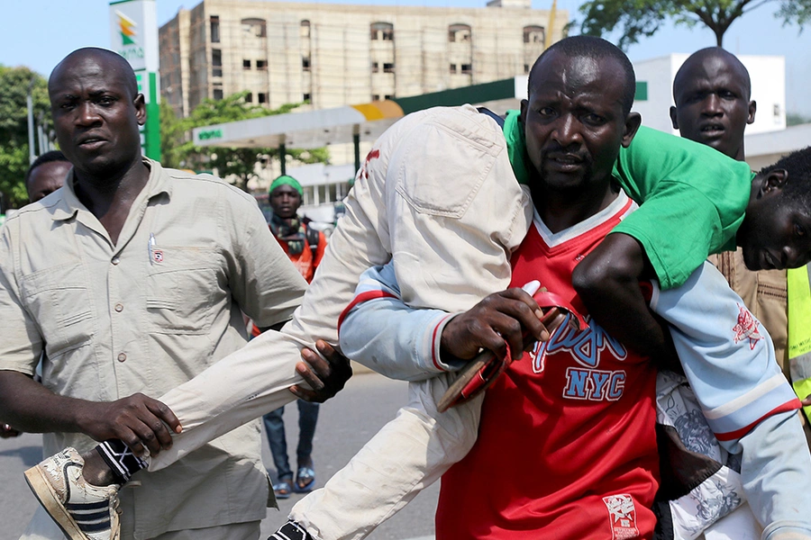 People carry a wounded person as Nigerian Shias gather during the Arbaeen ceremony in Abuja, Nigeria on October 30. The ceremony was marked by protests for el-Zakzaky's release and clashes with security services.