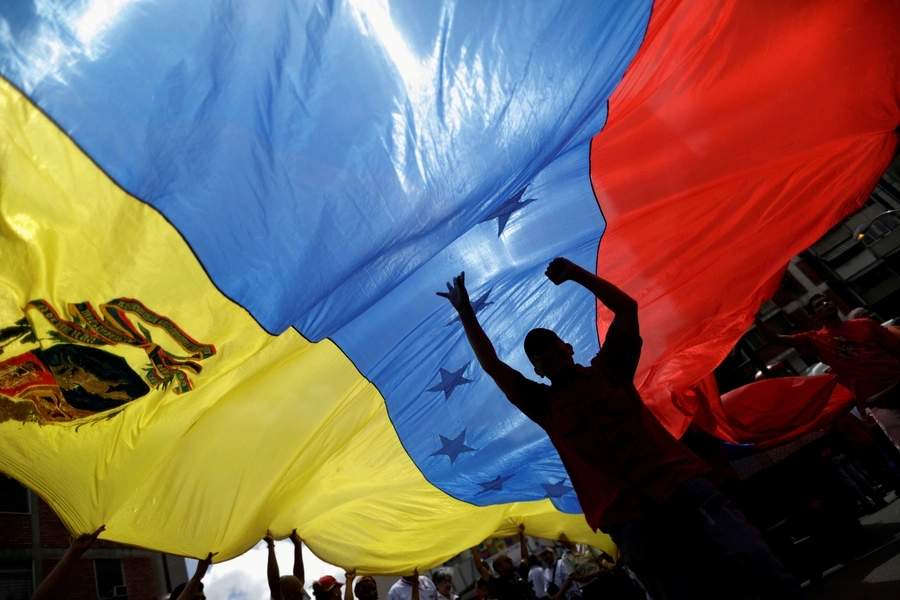 Pro-government supporters hold a Venezuela's flag at a rally in Caracas, Venezuela, in August 2017.