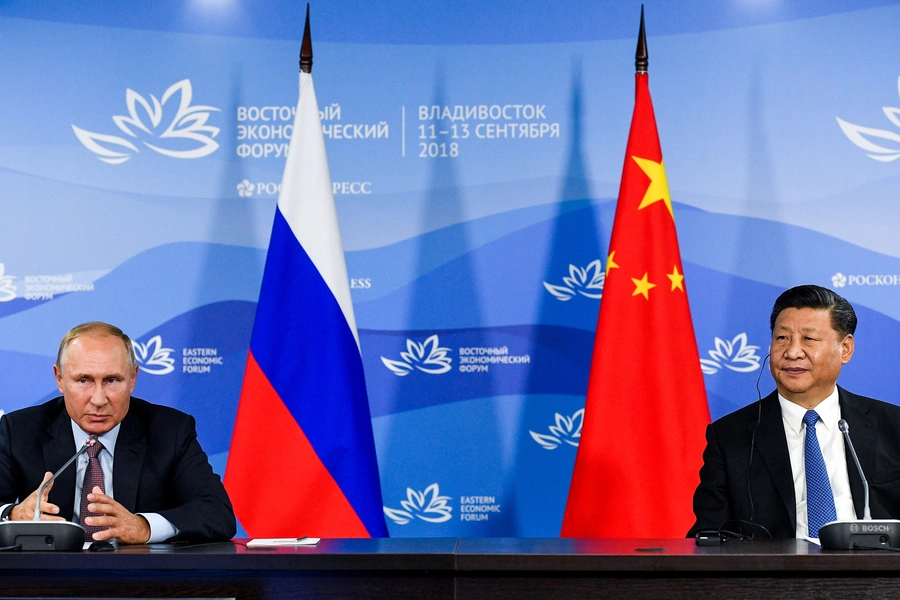 Russian President Vladimir Putin and Chinese President Xi Jinping attend a meeting with participants of a round table discussion on Russia-China Cooperation on the sidelines of the Eastern Economic Forum in Vladivostok, Russia September 11, 2018