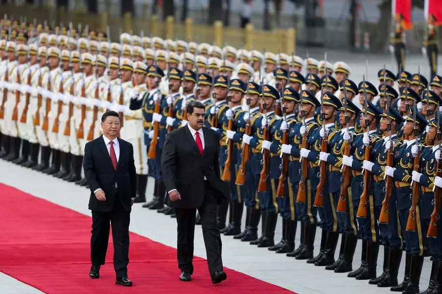 Chinese President Xi Jinping walks next to Venezuela's President Nicolas Maduro during his welcoming ceremony in Beijing on September 14, 2018.