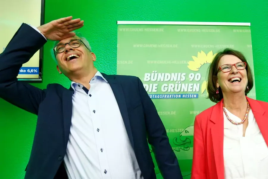 Green party top candidate and Minister of Economics, Energy, Transport and Regional Development of Hesse Tarek Al-Wazir and Minister For The Environment, Climate Protection, Agriculture And Consumer Protection of Hesse Priska Hinz react on first exit poll