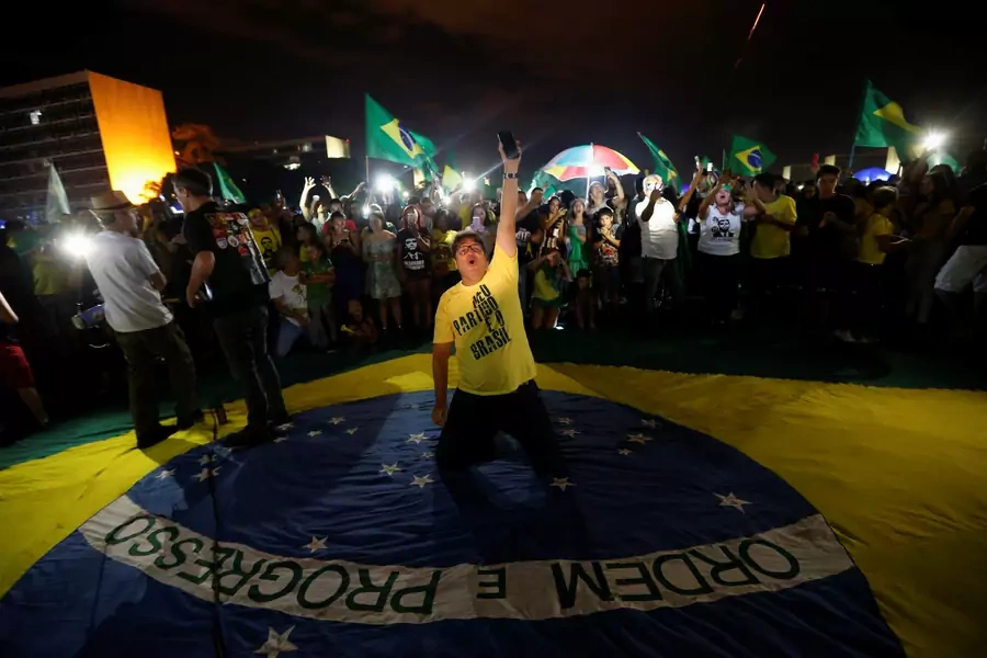 Supporters of Jair Bolsonaro, far-right lawmaker and presidential candidate of the Social Liberal Party, react after Bolsonaro wins the presidential race, in Brasilia on October 28, 2018.