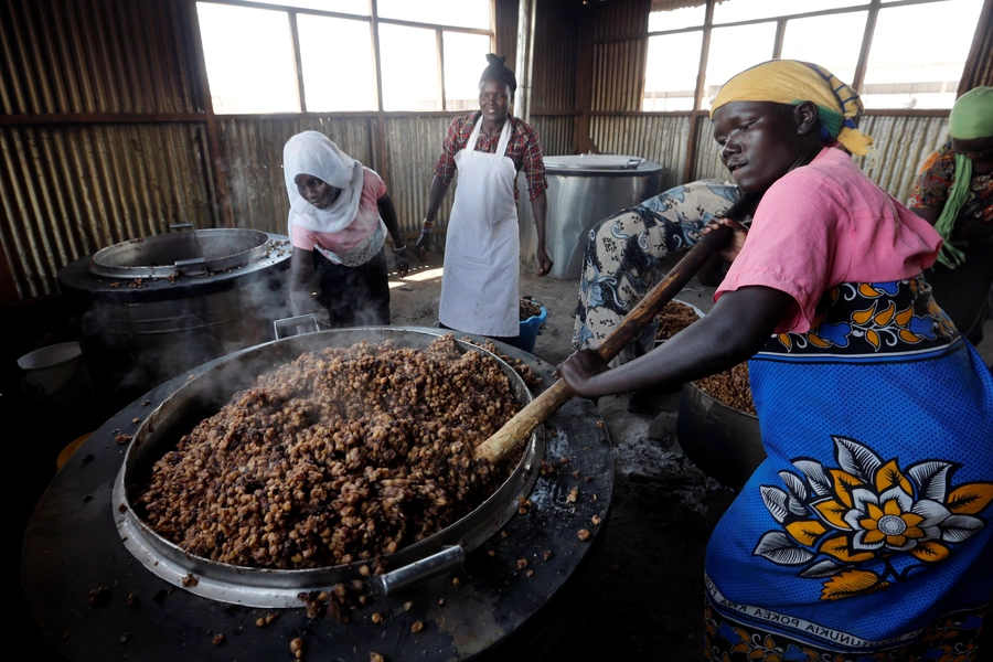 South Sudanese volunteers prepare food for refugees at Kalobeyei Primary school within Kalobeyei Settlement outside the Kakuma refugee camp in Turkana county, northwest of Nairobi, Kenya, on January 31, 2018. 