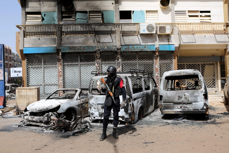 A soldier across the street from Splendid Hotel in Ouagadougou, Burkina Faso, on January 17, 2016, after security forces retook the hotel from al-Qaeda fighters who seized it in an assault that killed two dozen people from eighteen different countries.