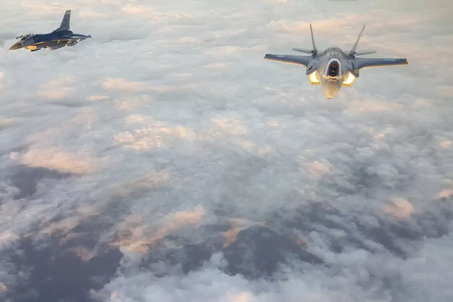 A U.S. Air Force F-16 (left) escorts a Japan Air Self-Defense Force F-35A (right) over the Pacific Ocean on November 6, 2017.